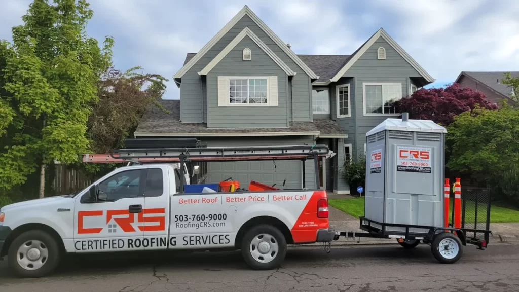 Certified Roofing Services truck and portable restroom parked in front of a modern Portland home, ready for a residential roofing project.
