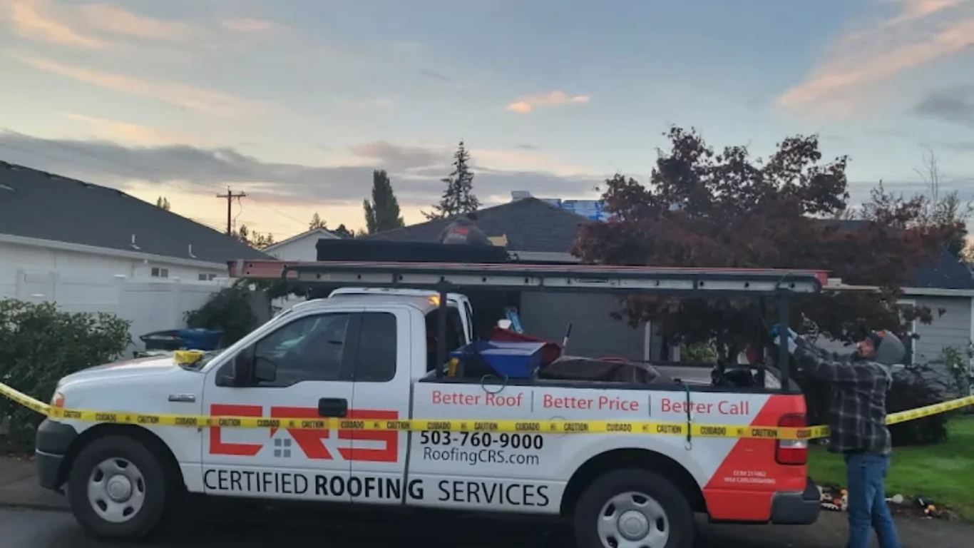 A Certified Roofing Services truck parked at a residential job site at dusk, with caution tape around the work area and a roofer visible on the house.